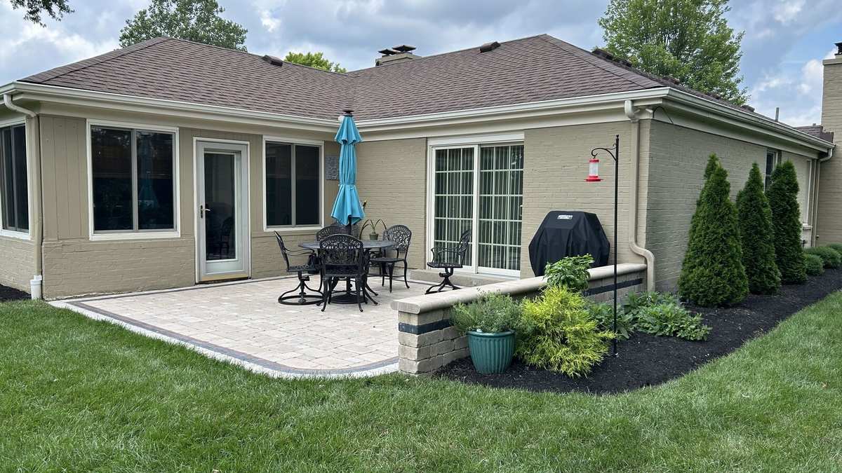 Finished paver patio with seat wall and plantings
