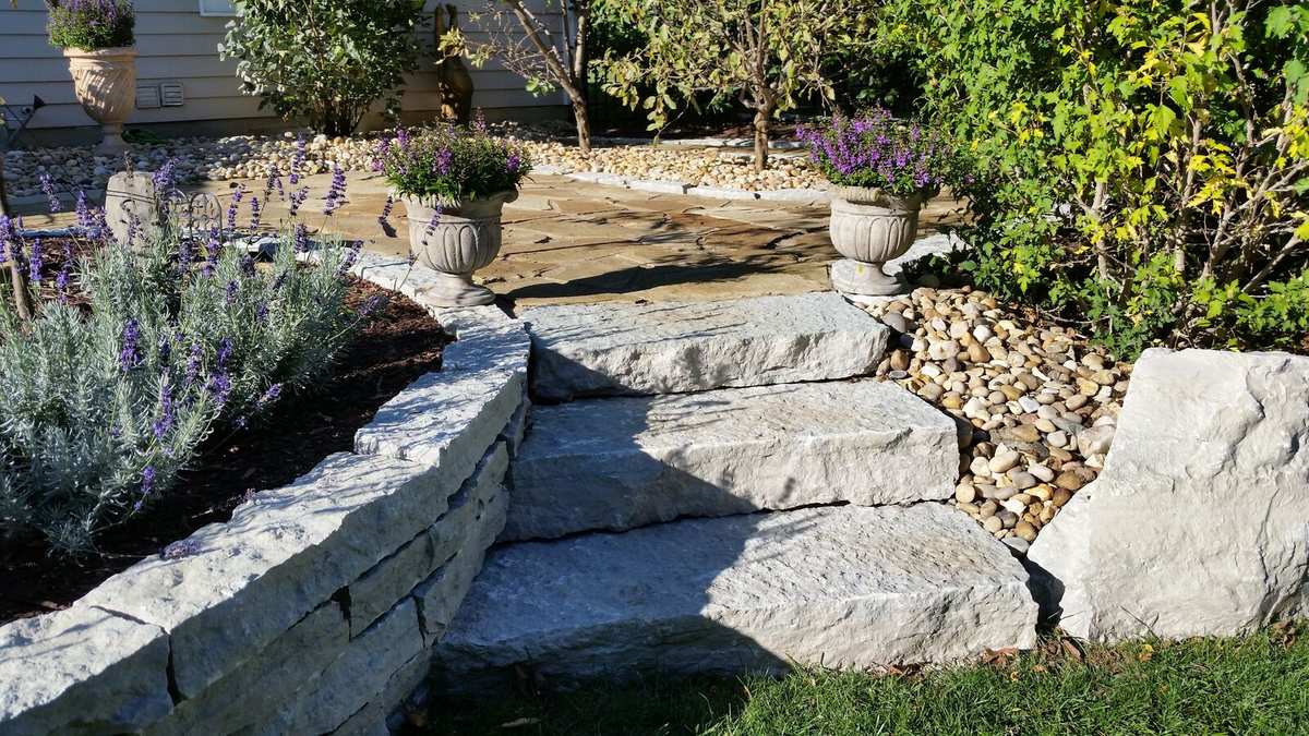 Installed natural stone steps and wall with plantings
