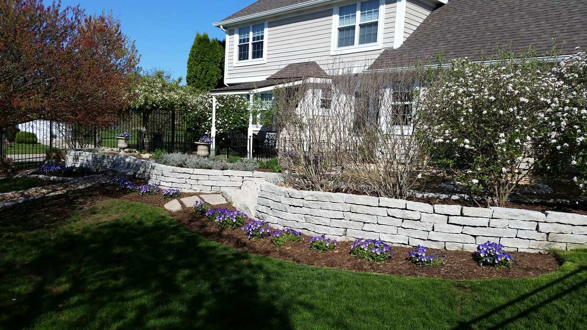 Natural stone retaining wall with flowering perennials